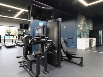 A gym with a variety of equipment including a leg press machine.
